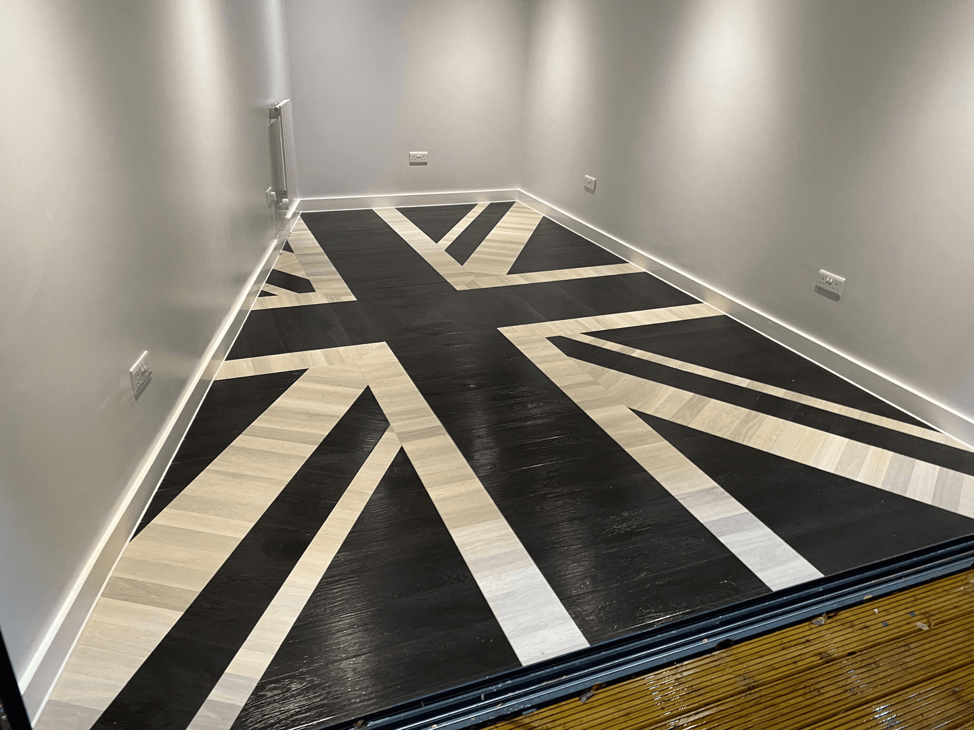 Custom Union Jack pattern in dark and light wood flooring