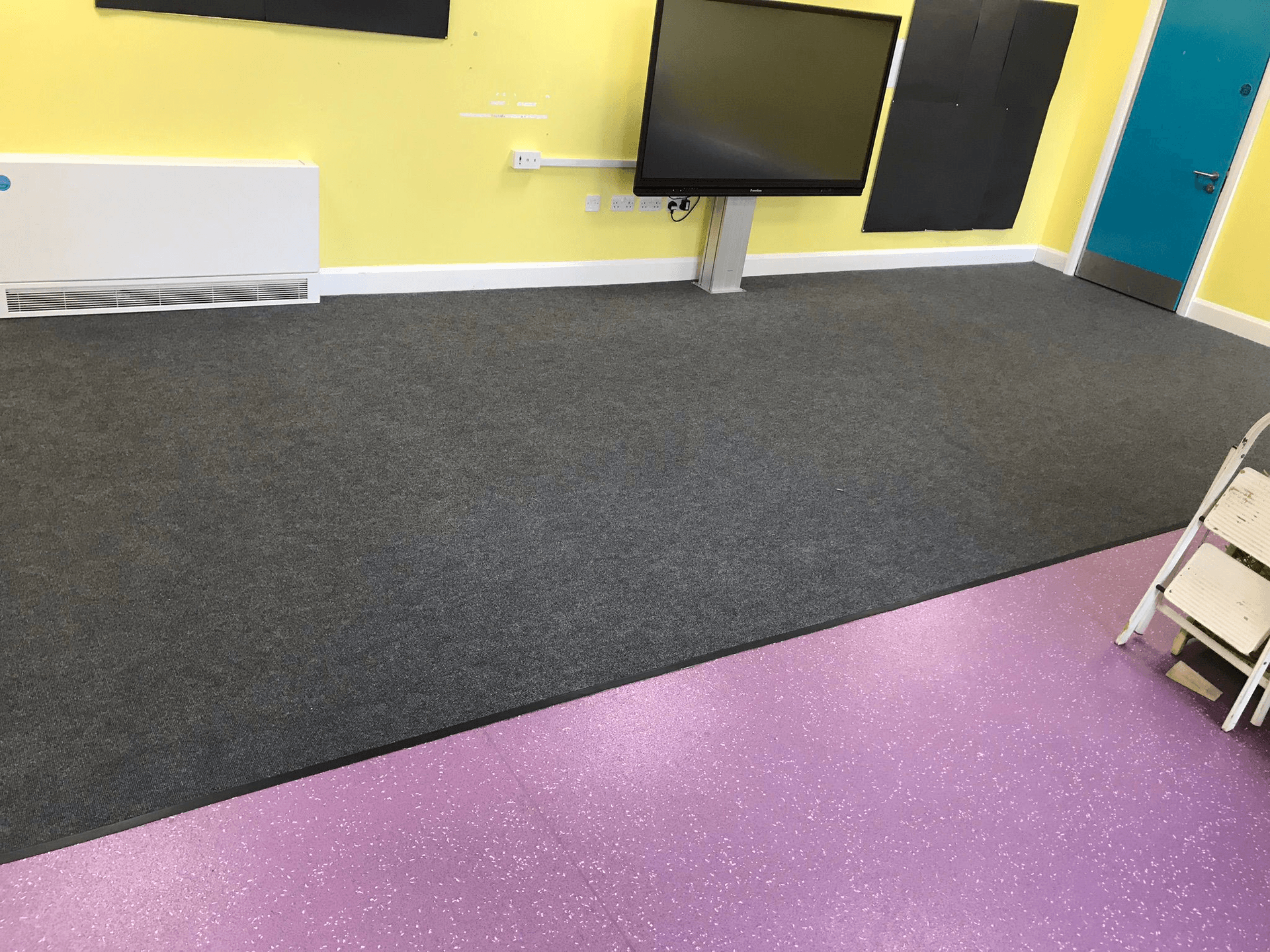 Carpet and safety vinyl flooring in a school classroom